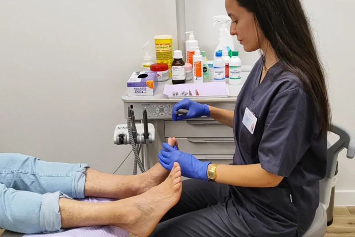 Profesional de podología atendiendo a una paciente